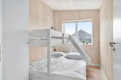 a bunk bed in a small room with a window at 158-Thisted-Lyngbakken-8 in Thisted