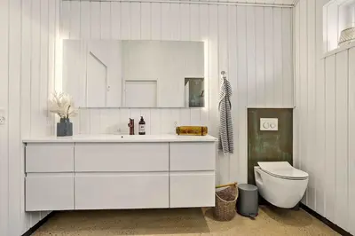a bathroom with a white sink and a toilet at 1314-Thisted-Lyngbakken-14 in Thisted