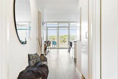 a hallway with a mirror and a dining room at 781-Thisted-Havstokken-28-A in Thisted