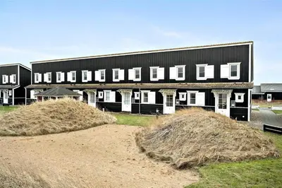 a large black building with hay bales in front of it at 212-Vestervig-Havnevej-1-lejl-12 in Vestervig