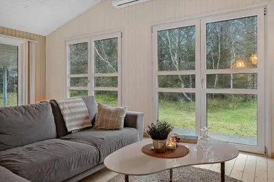 a living room with a couch and a table at 1067-Thisted-Gra-Rimme-7 in Torsted