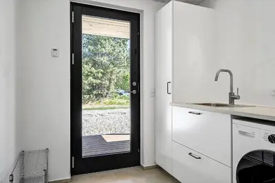 a kitchen with a door leading to a patio at 1323-Thisted-Fiskervej-96 in Thisted