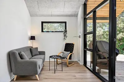 a living room with a couch and a chair at 1323-Thisted-Fiskervej-96 in Thisted