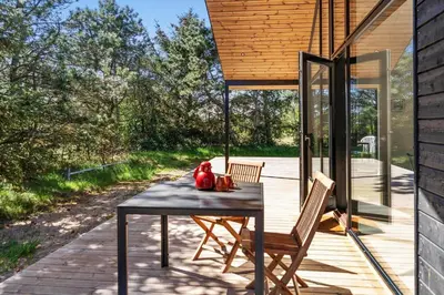 a table with two chairs and a red teddy bear on it at 1323-Thisted-Fiskervej-96 in Thisted