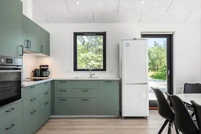 a kitchen with green cabinets and a white refrigerator at 1323-Thisted-Fiskervej-96 in Thisted