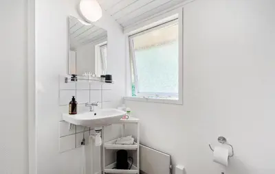 a white bathroom with a sink and a window at 3 Bedroom Amazing Home In Aabybro in Åbybro
