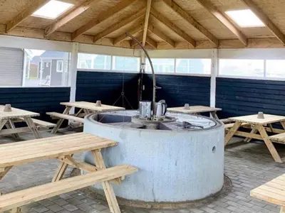 a hot tub in a room with picnic tables at 4 star holiday home in Thyborøn in Thyborøn
