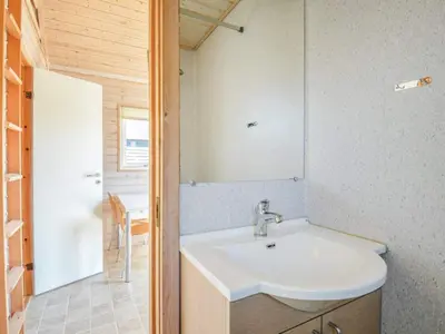 a bathroom with a sink and a mirror at 4 star holiday home in Thyborøn in Thyborøn