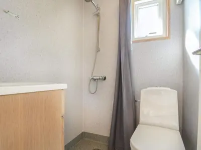 a bathroom with a shower with a toilet and a sink at 4 star holiday home in Thyborøn in Thyborøn