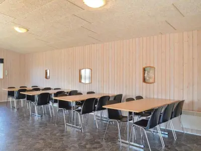 a row of tables and chairs in a room at 4 star holiday home in Thyborøn in Thyborøn