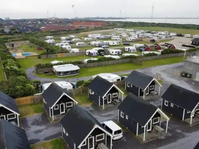 an aerial view of a parking lot with houses and vehicles at 4 star holiday home in Thyborøn in Thyborøn