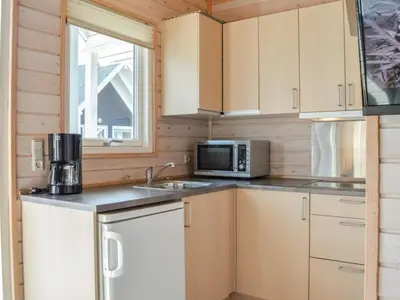 a kitchen with a sink and a microwave at 4 star holiday home in Thyborøn in Thyborøn