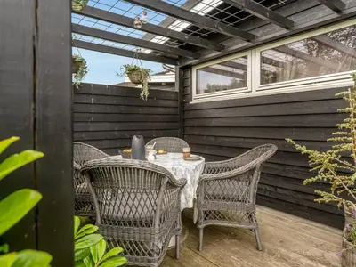 a table and chairs sitting on a patio at Holiday Home Diderik - 20m to the fjord by Interhome in Roslev