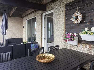 a wooden table with chairs and a bowl on a patio at 6 person holiday home in Vestervig in Vestervig
