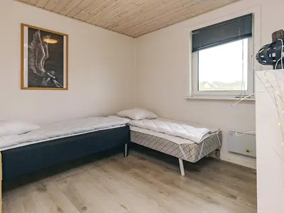 two beds in a room with a window at 6 person holiday home in Vestervig in Vestervig
