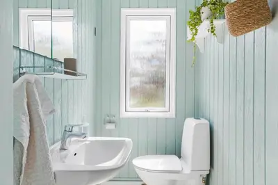 a bathroom with a sink and a toilet and a window at 399-Thisted-Sotungevej-21 in Nørre Vorupør