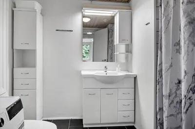 a white bathroom with a sink and a mirror at 724-Vestervig-Kanalvej-24 in Tåbel