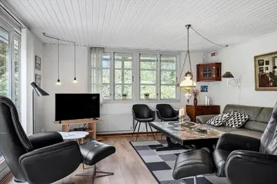 a living room with a couch and chairs and a tv at 724-Vestervig-Kanalvej-24 in Tåbel