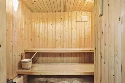 a wooden sauna with a bucket in it at 880-Thisted-Havtornvej-4 in Thisted