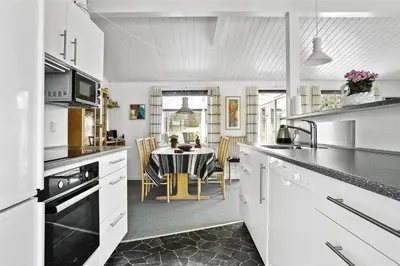 a kitchen with a table and a dining room at 880-Thisted-Havtornvej-4 in Thisted
