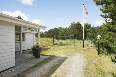 a house with a porch and a flag on a pole at 880-Thisted-Havtornvej-4 in Thisted