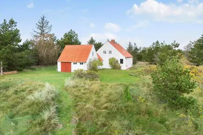 a white house with an orange roof on a field at 872-Bedsted-Thy-Lyngbyvej-25 in Bedsted Thy