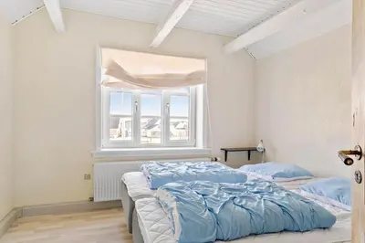 a bedroom with a large bed and a window at 823-Thisted-Knottivej-3 in Thisted