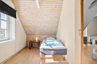a small bed in a room with a wooden ceiling at 823-Thisted-Knottivej-3 in Thisted