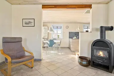 a living room with a chair and a fireplace at 823-Thisted-Knottivej-3 in Thisted