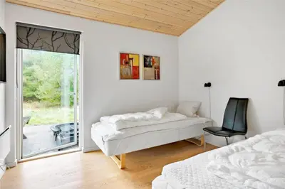 a bedroom with a bed and a sliding glass door at 454-Thisted-Havbovej-36 in Thisted