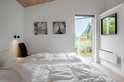 a white bedroom with a large bed and a window at 454-Thisted-Havbovej-36 in Thisted