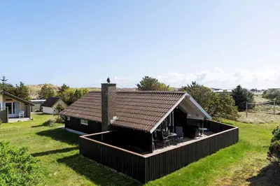 a house with a brown roof on a green field at 528-Thisted-Tunvej-28 in Thisted