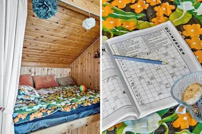a book and a bed in a room with flowers at 323-Thisted-Pighvarvej-27 in Thisted
