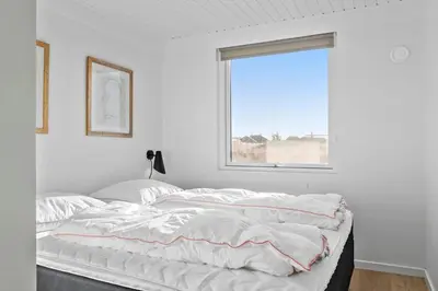 a white bedroom with a large bed and a window at 106-Thisted-Simonsvej-6 in Thisted