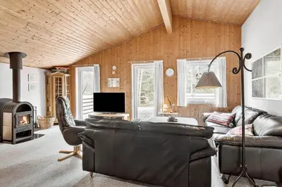 a living room with a couch and a tv at 560-Thisted-Klitrosevej-60 in Thisted