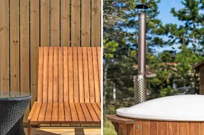 a wooden chair next to a wooden fence and a hot tub at 780-Thisted-Molgaardsvej-60 in Thisted