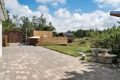 a patio with a bench and a fire place at 780-Thisted-Molgaardsvej-60 in Thisted