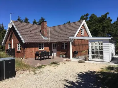 a brick house with a table in front of it at 707-Thisted-Lyngvej-12 in Thisted