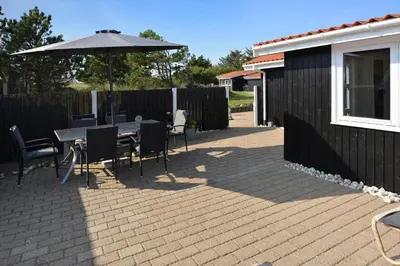 a patio with a table and an umbrella at 1303-Thisted-Fiskervej-47 in Thisted