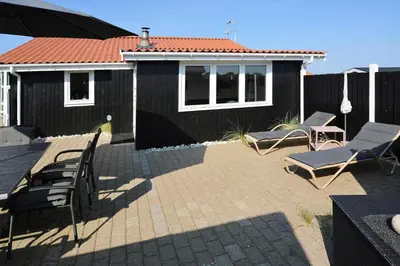 a patio with some chairs and a house at 1303-Thisted-Fiskervej-47 in Thisted