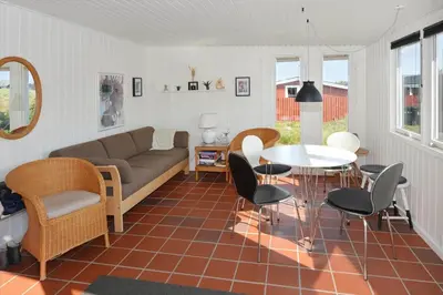 a living room with a couch and a table and chairs at 1303-Thisted-Fiskervej-47 in Thisted