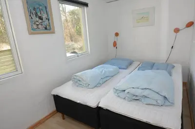two twin beds in a room with two windows at 168-Thisted-Sandtornvej-8 in Thisted