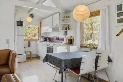 a kitchen with a table and chairs in a room at 168-Thisted-Sandtornvej-8 in Thisted