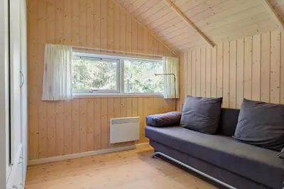 a living room with a couch and a window at 876-Thisted-Klemsvej-27 in Thisted