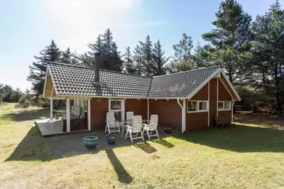 a small cabin with a table and chairs in the yard at 876-Thisted-Klemsvej-27 in Thisted