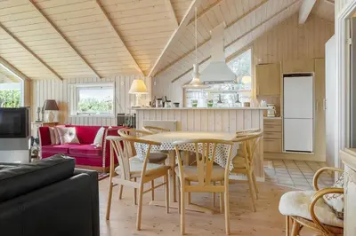 a kitchen and living room with a table and chairs at 876-Thisted-Klemsvej-27 in Thisted