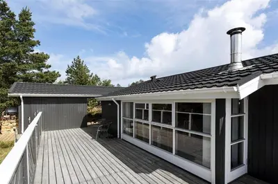 a house with a deck with a roof at 705-Thisted-Klitrosevej-22 in Thisted