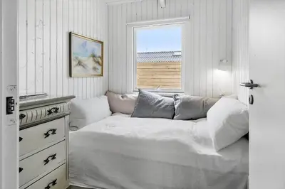 a white bedroom with a bed and a window at 1014-Thisted-Sletningen-7 in Torsted