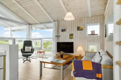 a living room with a couch and a table at 334-Snedsted-Somaerkevej-64-B in Snedsted