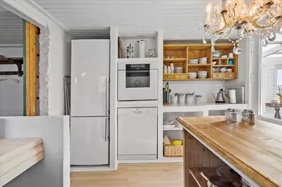 a kitchen with a white refrigerator and a table at 846-Thisted-Vesterhavsgade-6-A in Thisted